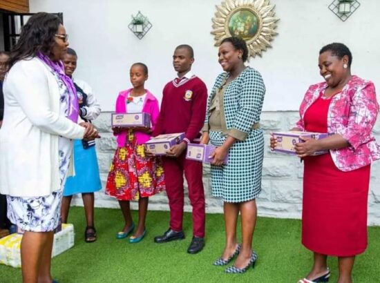 Mama Ida Odinga, gifts Wellington Otieno, the teenager who gifted the Azimio la Umoja-One Kenya coalition party Raila Odinga a State House model packets of biscuits.